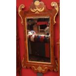 Large walnut Chippendale style parcel gilded wall mirror, of rectangular form, decorated with "C"