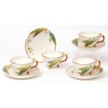 Set of four Brownfield decorative cabinet cups and saucers, the handles and saucer rims moulded with