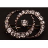 Victorian precious metal double crescent brooch, the centre old brilliant cut diamond (0.17ct app)