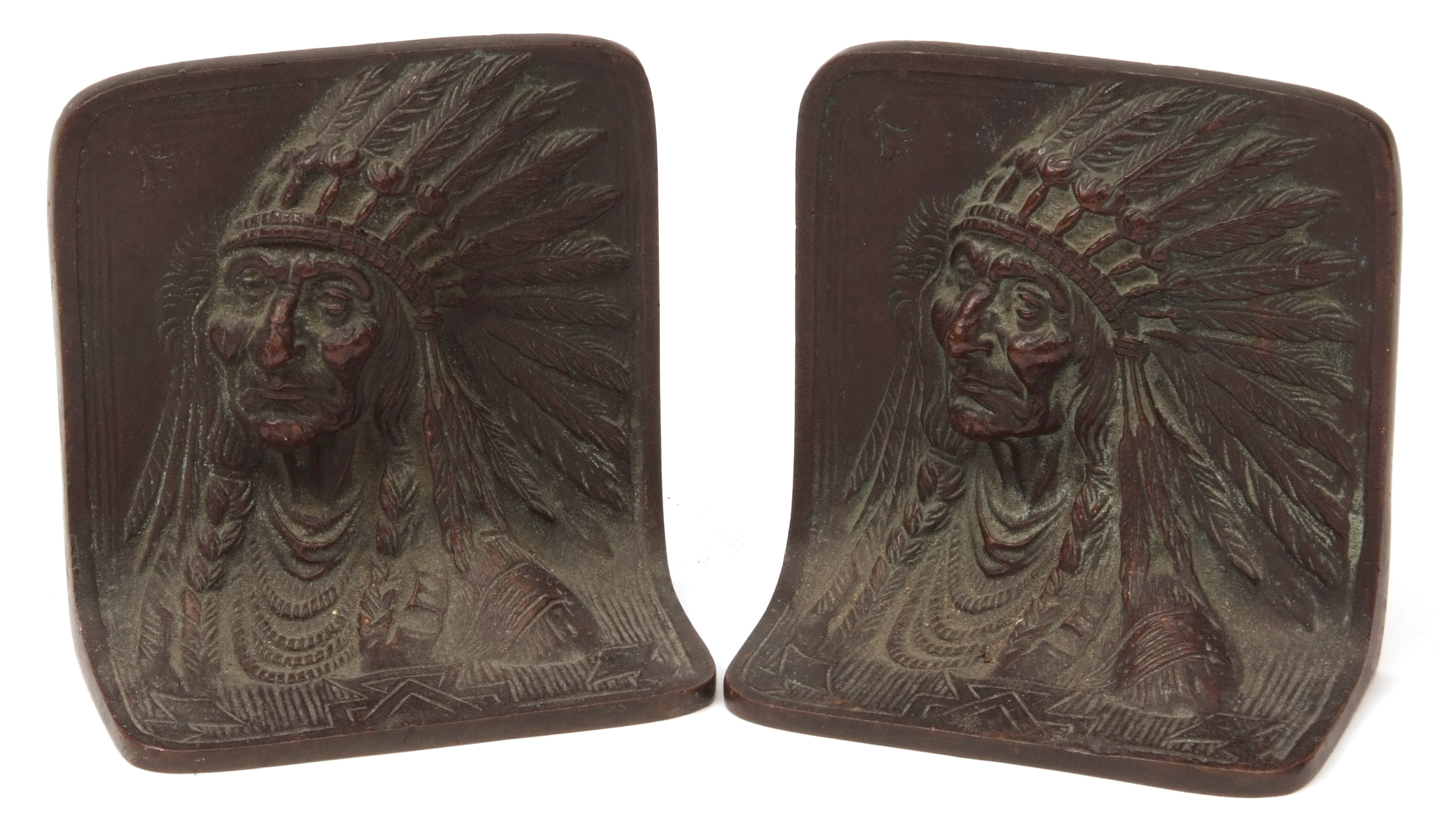 Pair of bronze book-ends, each decorated with head and shoulders portraits of native American