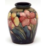 Moorcroft baluster vase decorated with an African Lily design on a blue green ground, impressed