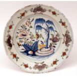 English Delft circular dish, painted throughout in colours with central scene of flowering tree,