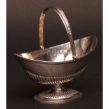 Victorian swing handle sugar basin of half fluted oval form with applied strap work handle and