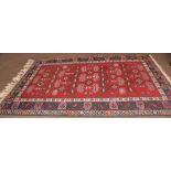 Caucasian wool carpet, triple gull border, central panel of geometric designs, mainly red and blue