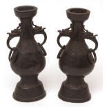 Pair of heavily cast pear shaped Chinese bronze vases of archaic form with Kylin and ring handles,