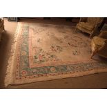 Large Indian or Chinese carpet, twining floral sprigs and lozenges within a triple gull border,