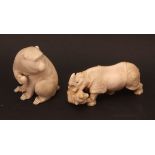 Two Meiji period Japanese ivory Okimono, the first an unusual depiction of a rhinoceros and lion