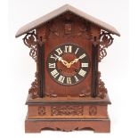 Late 19th century oak and ebonised table top cuckoo clock, the architectural case with scrolling