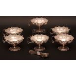Six clear glass lined dessert bowls, of circular form with pierced galleries with cast and applied