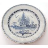 European Delft circular plate, centre typically painted in underglaze blue with flowering tree