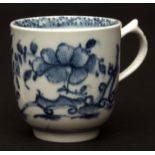 An early Lowestoft cup c1760, with pointed thumb rest, decorated with floral motifs in a Delft style
