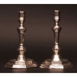 Two French early 18th century candlesticks, each with spreading octagonal bases to knopped and