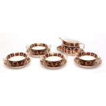Set of four Royal Crown Derby modern two-handled circular consomm bowls on stands, together with