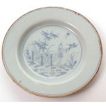 18th century English Delft circular plate, the centre decorated with an Oriental pattern in