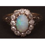 Mid-20th century opal and diamond cluster ring, the oval cabochon cut opal (10 x 6mm) surrounded