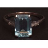 Precious metal aquamarine and diamond ring, the rectangular shaped stepped cut aquamarine (approx