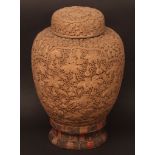 A Chinese moulded ginger jar and cover on fitted wood and silk stand, densely decorated with