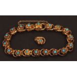 Victorian gold and turquoise bracelet, having 18 embossed gold flower head links, each with a