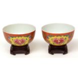 Fine pair of Chinese porcelain coral ground famille rose "Peony" bowls, the deeply rounded sides