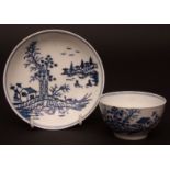 A Lowestoft tea bowl and saucer c1780 decorated with a printed design of a hut and sampan and a