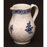 A Lowestoft sparrow beak jug c1765 the moulded pear shaped body with trailing flowers bordering