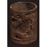 A heavily cast Chinese bronze brush pot of double skin construction showing scholars and