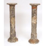 Pair of veined marble torchere stands, with canted square tops, raised on ring turned columns,