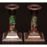 Two Edward VII hallmarked silver and enamelled squat candlesticks, each with detachable nozzles