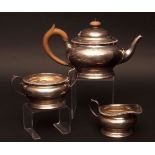George V three piece tea set comprising tea pot, sugar basin and milk jug, each of compressed and