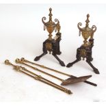 Pair of Victorian brass and anodised andirons, each crested with campana shaped urns and raised on