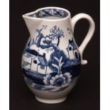 A Lowestoft sparrow beak jug c1770 of typical pear shape form decorated with houses and trees with a