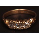 Yellow metal three-stone diamond ring, the three brilliant cut circular diamonds claw set in a