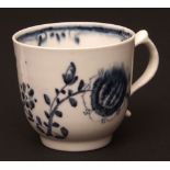 A Lowestoft coffee cup c1768 painted in a grey blue tone with a central flowerhead and trailing