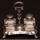 Early Victorian inkstand, the platform base of waisted rectangular form, raised on hollow cast and