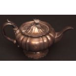 William IV tea pot of compressed and lobed circular form, hinged and domed cover with cast and