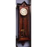 Late 19th century walnut and ebonised single weight Vienna type timepiece, the overhanging cornice