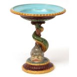 Minton Majolica tazza, the support formed as a coiled dolphin, painted in typical colours, impressed
