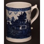 A Lowestoft mug c1780 transfer printed with a version of the temple or willow pattern below a cell