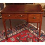 Edwardian mahogany writing table with red leather inset over two frieze drawers, raised on