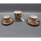 Two Crown Derby decorated cups and saucers, together with a modern Old Imari decorated mug