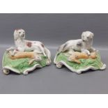 Pair of 19th century Staffordshire style recumbent dogs with hair to feet, raised on scrolling