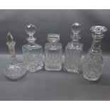 Group of cut glass decanters, to include three square-bodied decanters with varying stoppers,