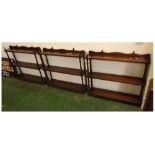 Set of three matching wall mounted mahogany book shelves with turned supports, three fixed