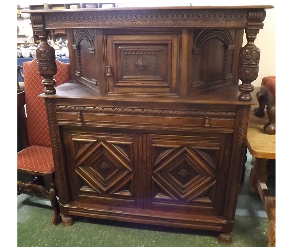 20th century Gothic carved court cupboard, fitted with central drawer with two bulbous column