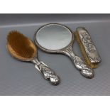 Three piece silver dressing table set, with pressed cherub detail, comprising of a hand-mirror,