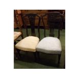 Pair of Edwardian splat back bedroom chairs with pierced decoration, upholstered seats on tapering