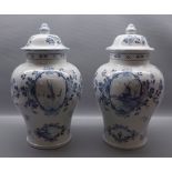 Pair of 20th century Delft Ware bulbous vases and lids with floral decoration with windmill