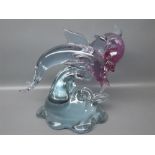 20th century coloured glass model of dolphins leaping out of the waves, signed to the foot "Pino