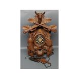 20th century Black Forest wall mounted cuckoo clock with hanging game detail and heavily carved