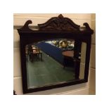 Walnut formed wall mirror with arched and bevelled glass, carved plinth with swan neck pediment (